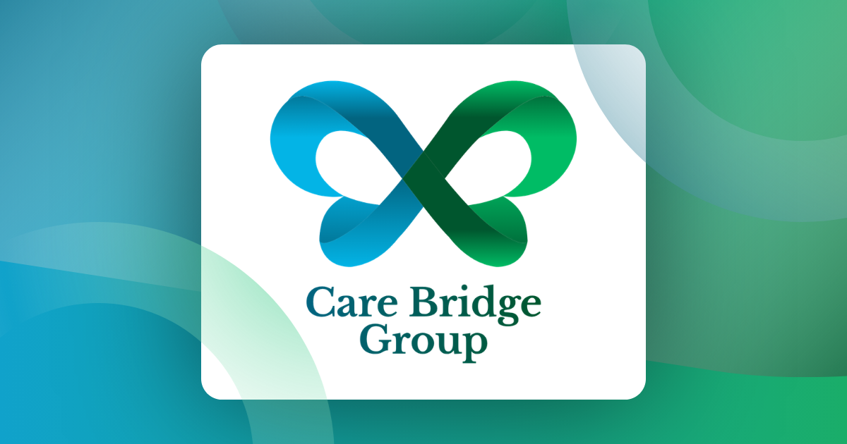 A Care Bridge Group nurse sitting with an elderly patient, sharing a warm moment of care